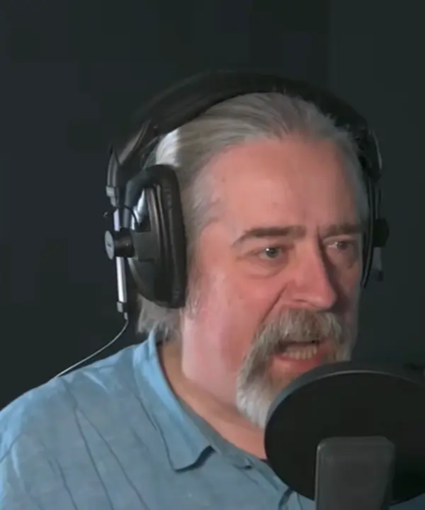 Andrew James Spooner recording at a microphone